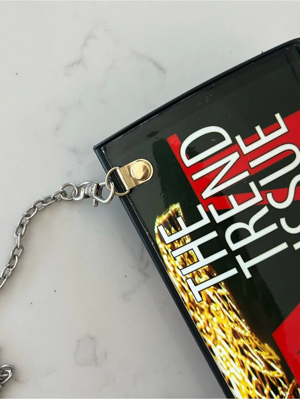 Edgy 80s rolled magazine clutch hard case with crossbody chain red and black